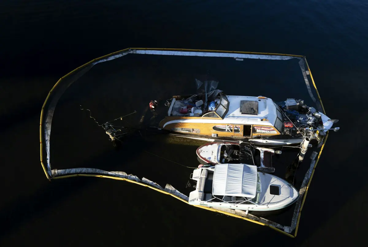 Oil containment booms on water contaminated by hydrocarbons